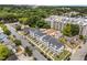 High-angle shot of modern townhomes amidst green trees, with neighborhood streets and a construction area nearby at 710 W North St # 103, Raleigh, NC 27603