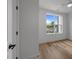 Bright bedroom with hardwood flooring and a large window offering neighborhood views at 710 W North St # 103, Raleigh, NC 27603
