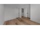 An empty bedroom featuring wood floors, fresh paint, and multiple entry doors at 710 W North St # 103, Raleigh, NC 27603