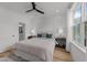 Bright bedroom with light wood floors, ceiling fan, and natural light from the window at 710 W North St # 103, Raleigh, NC 27603