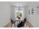 Cozy dining room with a modern light fixture and a window offering natural light at 710 W North St # 103, Raleigh, NC 27603