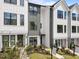 Modern townhouse showcases mixed siding materials, neat landscaping, and welcoming walkways at 710 W North St # 103, Raleigh, NC 27603