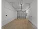 Spacious two car garage with white walls, sealed concrete floor and access door at 710 W North St # 103, Raleigh, NC 27603