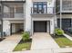 Attached garage with a door and small yard; driveway has parking for a car and access to other areas at 710 W North St # 103, Raleigh, NC 27603