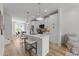 Bright open-concept kitchen featuring a kitchen island with bar seating and stainless steel appliances at 710 W North St # 103, Raleigh, NC 27603