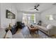 Bright living room featuring modern decor, a ceiling fan, and a balcony with natural light at 710 W North St # 103, Raleigh, NC 27603