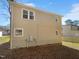 Side exterior view of home with siding and various windows and a spacious yard at 720 Rawls Dr, Raleigh, NC 27610