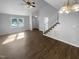 Spacious open-concept living area with hardwood floors, staircase, and a large window for plenty of natural light at 720 Rawls Dr, Raleigh, NC 27610