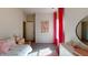 Bright bedroom with whimsical decor, a cozy bed, and a large mirror, creating an inviting and cheerful space at 75 E American Marigold Dr # 37, Benson, NC 27504