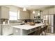 Bright kitchen features stainless steel appliances, large island with seating, and neutral color palette at 75 E American Marigold Dr # 37, Benson, NC 27504