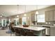 Open concept kitchen with a large island, bar seating, and stainless steel appliances provides ample space at 75 E American Marigold Dr # 37, Benson, NC 27504