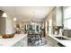 Open-concept kitchen boasts modern cabinetry, stainless steel appliances, and a view of the dining area at 75 E American Marigold Dr # 37, Benson, NC 27504