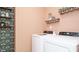 Laundry room with new appliances, custom wall paper and a clean and functional space at 75 E American Marigold Dr # 37, Benson, NC 27504