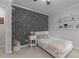Cozy bedroom features a unique wallpaper accent wall and a reading nook at 7517 Chippenham Ct, Raleigh, NC 27613