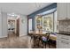 Bright breakfast nook with bay window, cozy seating, and hardwood floors at 7517 Chippenham Ct, Raleigh, NC 27613