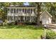 Charming two-story home with a well-manicured lawn, black shutters, and attached two-car garage at 7517 Chippenham Ct, Raleigh, NC 27613