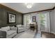 Cozy home office with stylish wood paneling, comfortable seating, and ample natural light at 7517 Chippenham Ct, Raleigh, NC 27613