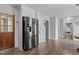 Modern kitchen with stainless steel refrigerator, warm wood floors, and easy access to the entryway at 7517 Chippenham Ct, Raleigh, NC 27613