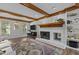 Inviting living room with wood beams, fireplace, and built-in shelving perfect for cozy evenings at 7517 Chippenham Ct, Raleigh, NC 27613