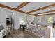 Bright and airy living room featuring hardwood floors, beamed ceilings, and natural light at 7517 Chippenham Ct, Raleigh, NC 27613