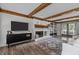 Elegant living room with a white brick fireplace, built-in shelves, and wood-beamed ceilings at 7517 Chippenham Ct, Raleigh, NC 27613