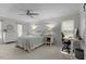 Spacious bedroom featuring neutral paint, soft carpet, ceiling fan, desk/workspace, and multiple windows for natural light at 7517 Chippenham Ct, Raleigh, NC 27613