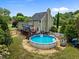 Aerial view of backyard featuring an above ground pool, deck, play area, and fenced in yard at 7621 Troy Stone Dr, Fuquay Varina, NC 27526