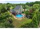 Aerial view of backyard featuring a large above ground pool, deck, and playground at 7621 Troy Stone Dr, Fuquay Varina, NC 27526