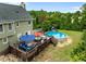Aerial view of backyard featuring a large deck, an above ground pool, and a play set at 7621 Troy Stone Dr, Fuquay Varina, NC 27526