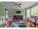 Bright playroom features laminate floors, natural light and a ceiling fan at 7621 Troy Stone Dr, Fuquay Varina, NC 27526
