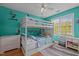 bedroom featuring a bunk bed, ceiling fan, and window bringing in ample natural light at 7621 Troy Stone Dr, Fuquay Varina, NC 27526