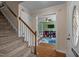 Welcoming entryway with carpeted stairs leading upstairs, and an arched opening to a play area at 7621 Troy Stone Dr, Fuquay Varina, NC 27526