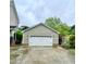Spacious detached two-car garage featuring an extra-wide driveway, and manicured landscape at 7621 Troy Stone Dr, Fuquay Varina, NC 27526