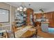 Inviting eat-in kitchen features wood cabinets, decorative chandelier, and stainless steel appliances at 7621 Troy Stone Dr, Fuquay Varina, NC 27526