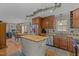Bright kitchen featuring wood cabinets, stainless steel appliances, a butcher block island and an eat-in table at 7621 Troy Stone Dr, Fuquay Varina, NC 27526