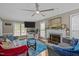 Bright and airy living room featuring a fireplace, plush seating, and modern ceiling fan at 7621 Troy Stone Dr, Fuquay Varina, NC 27526
