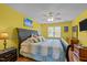 Comfortable primary bedroom features laminate floors, a ceiling fan, and an ensuite bathroom at 7621 Troy Stone Dr, Fuquay Varina, NC 27526