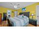 This sunny primary bedroom features laminate floors, a ceiling fan, and ample closet space at 7621 Troy Stone Dr, Fuquay Varina, NC 27526