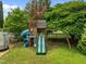 playground featuring multiple slides, a swing set, and climbing area in a fenced in yard at 7621 Troy Stone Dr, Fuquay Varina, NC 27526