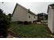 Exterior view featuring a tidy backyard, with an outbuilding, a swing set, and mature trees at 780 Pondview Ct, Rocky Mount, NC 27804