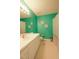Bathroom featuring a white vanity, toilet, and shower-tub with a teal accent wall at 780 Pondview Ct, Rocky Mount, NC 27804