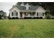 Charming single-Gathering home showcasing a well-maintained lawn and inviting front porch at 780 Pondview Ct, Rocky Mount, NC 27804