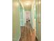 Hallway featuring wood-look floors, light green walls, and doorways to the bedrooms and bathroom at 780 Pondview Ct, Rocky Mount, NC 27804