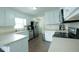 Bright kitchen features white cabinetry, stainless steel appliances, and durable tile flooring at 780 Pondview Ct, Rocky Mount, NC 27804