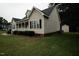 Well-maintained side of the home featuring classic siding, trimmed bushes, and tidy lawn at 780 Pondview Ct, Rocky Mount, NC 27804