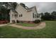 Side of the house featuring manicured lawn, trimmed bushes, and inviting architecture at 780 Pondview Ct, Rocky Mount, NC 27804
