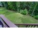 Large backyard with a lush lawn and privacy, accessible from the deck and stairs at 82 Idlewood Ln, Clayton, NC 27527