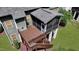 Aerial view of a home's wood deck and screened in porch that lead down to the green lawn at 82 Idlewood Ln, Clayton, NC 27527