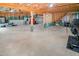 Unfinished basement space with exposed beams, concrete floor, and fitness equipment at 82 Idlewood Ln, Clayton, NC 27527