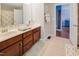 Bright bathroom features a double vanity, tile floors, and opens to bedroom with unique wall paper design at 82 Idlewood Ln, Clayton, NC 27527